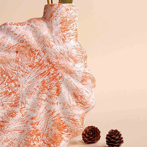 Stylish shell-inspired vase in a soft coral blush finish

