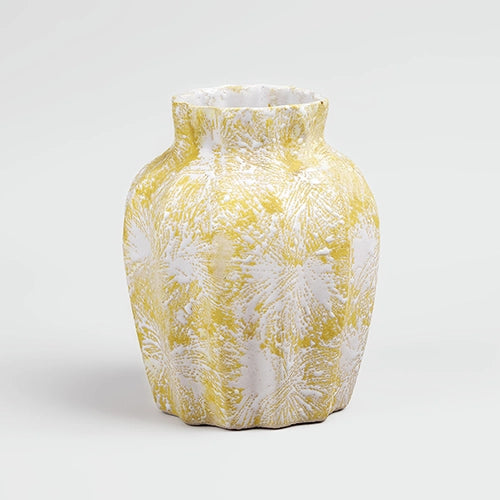 Decorative cream vase featuring a scalloped textured finish

