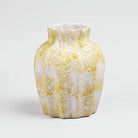 Decorative cream vase featuring a scalloped textured finish

