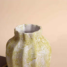 Cream flower vase with intricate scalloped texture

