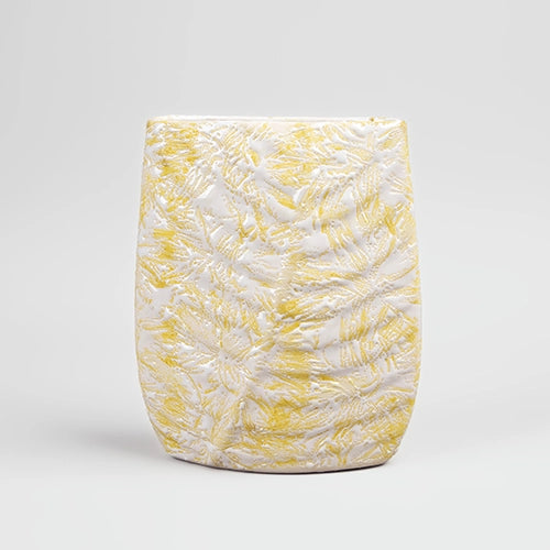Decorative cream vase featuring a detailed leaf imprint

