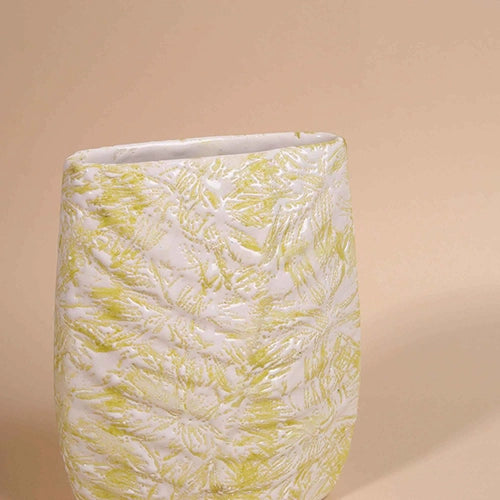 Textured cream vase with intricate botanical leaf detailing

