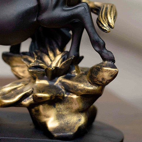 Majestic black and golden horse statues displayed together

