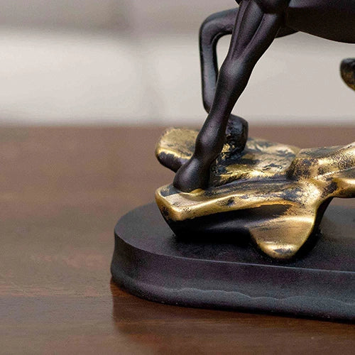 Twin horse figurines with black and gold decorative finish

