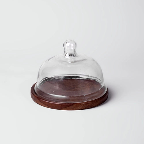 Decorative glass dome with wooden serving tray
