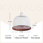 Elegant glass cloche and wooden tray for home decor
