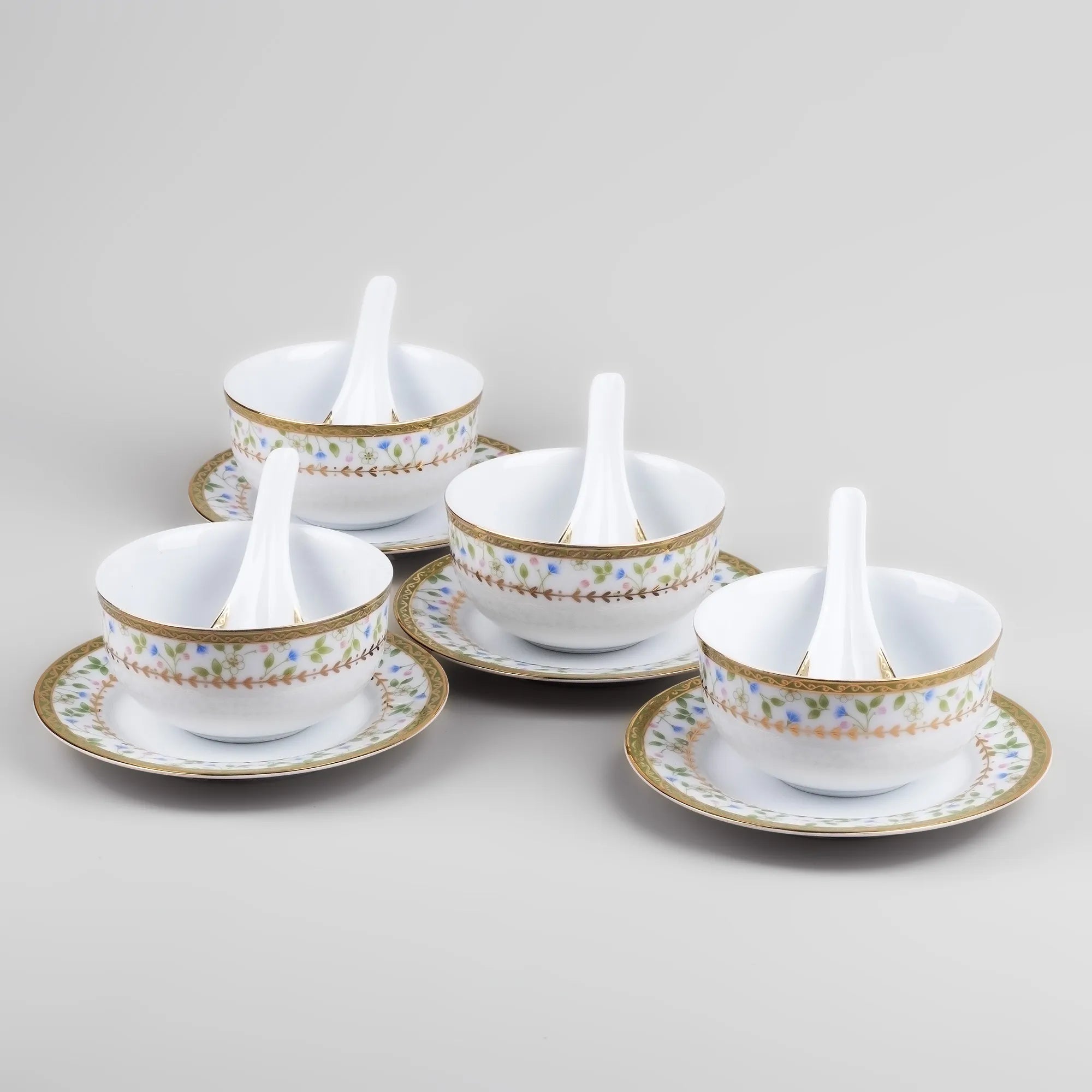 Decorative porcelain bowls with matching spoons for serving

