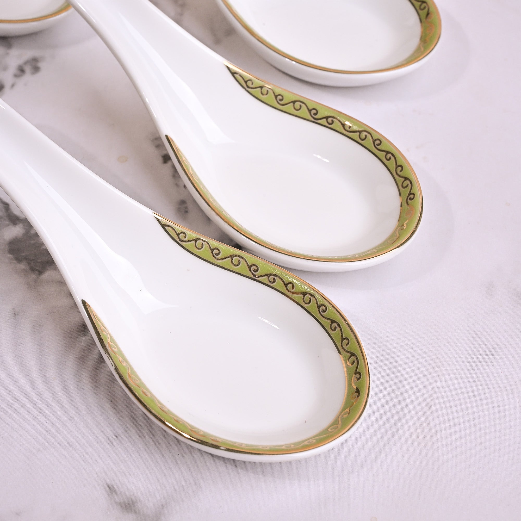 Set of four porcelain bowls with matching ceramic spoons


