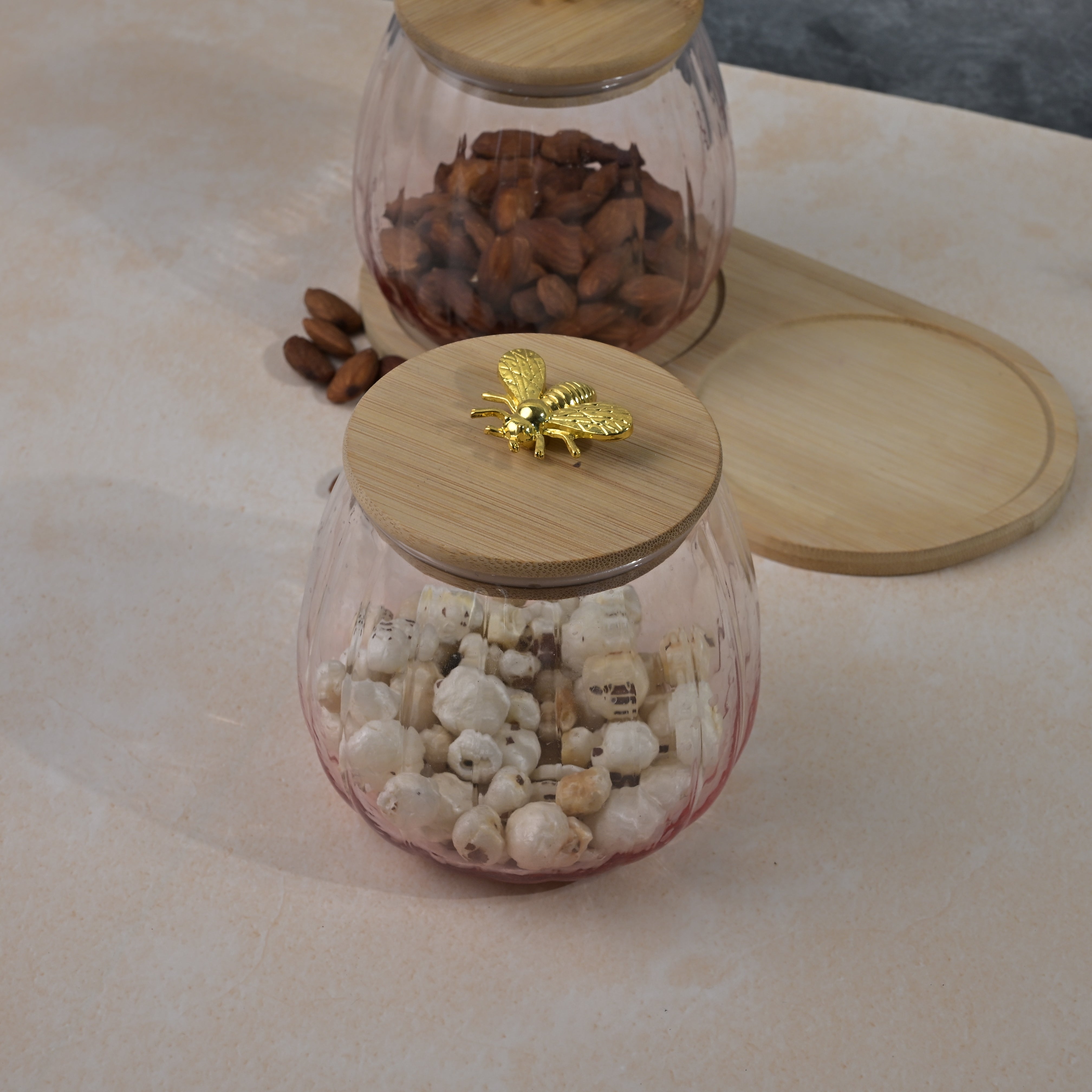 Clear glass jar with wooden cover for food storage
