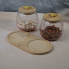 Clear kitchen storage jar with wooden lid
