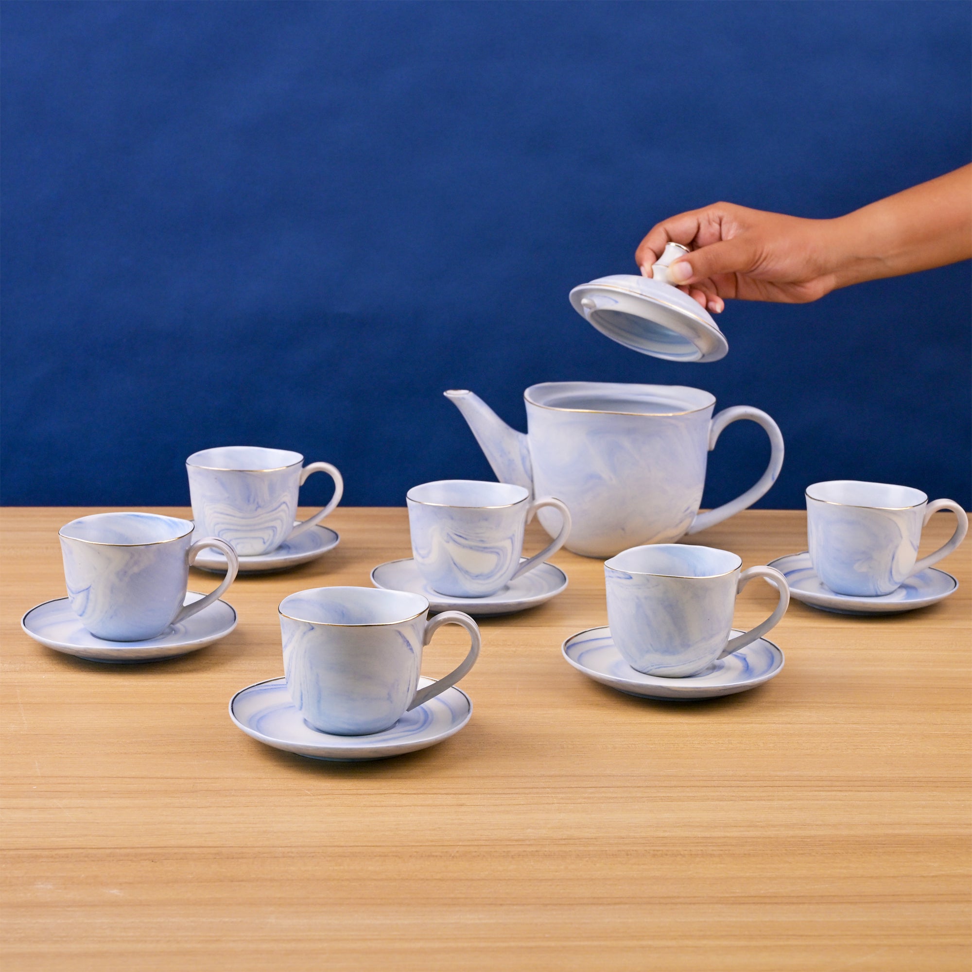 Sky blue tea kettle with cups

