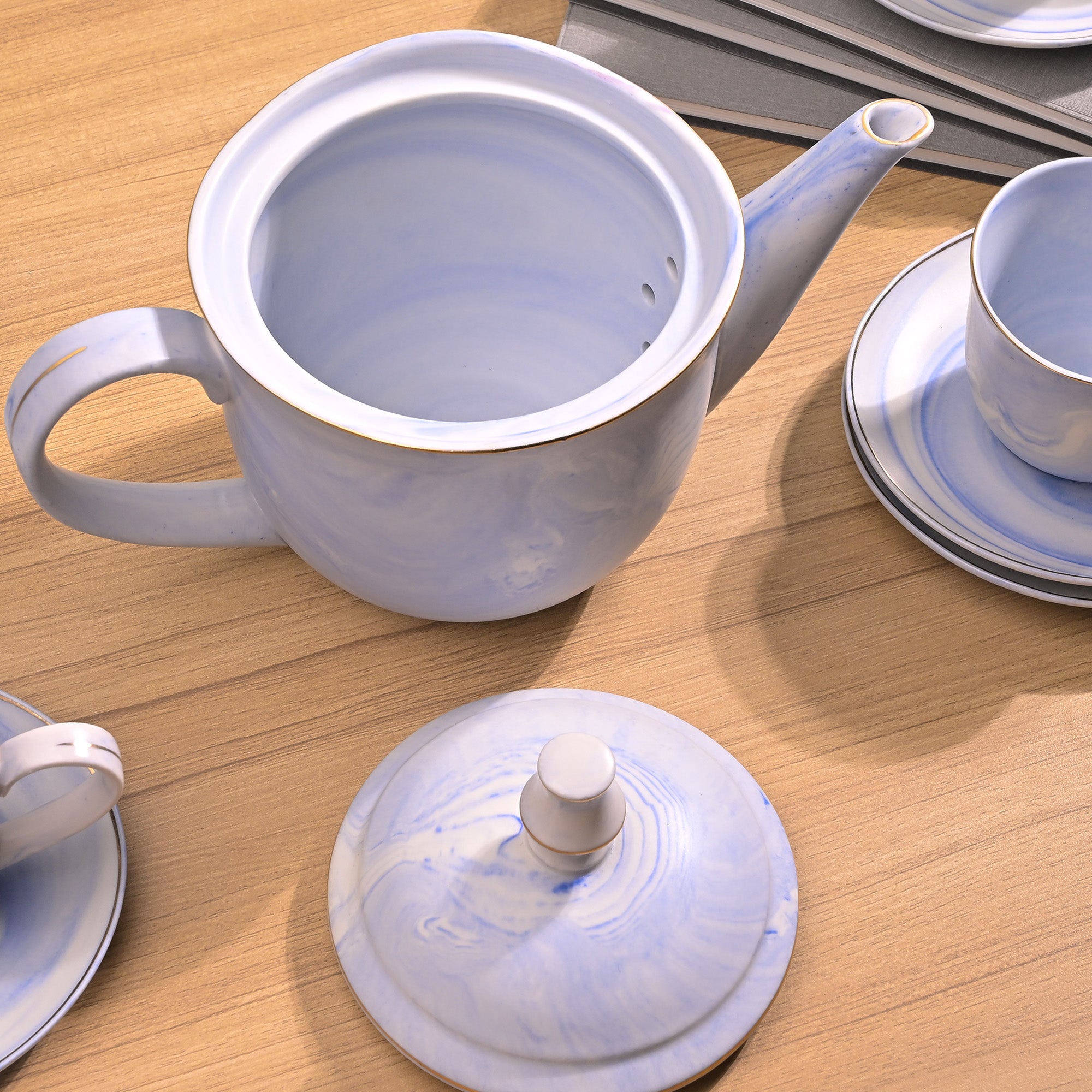 Faded blue ceramic tea kettle

