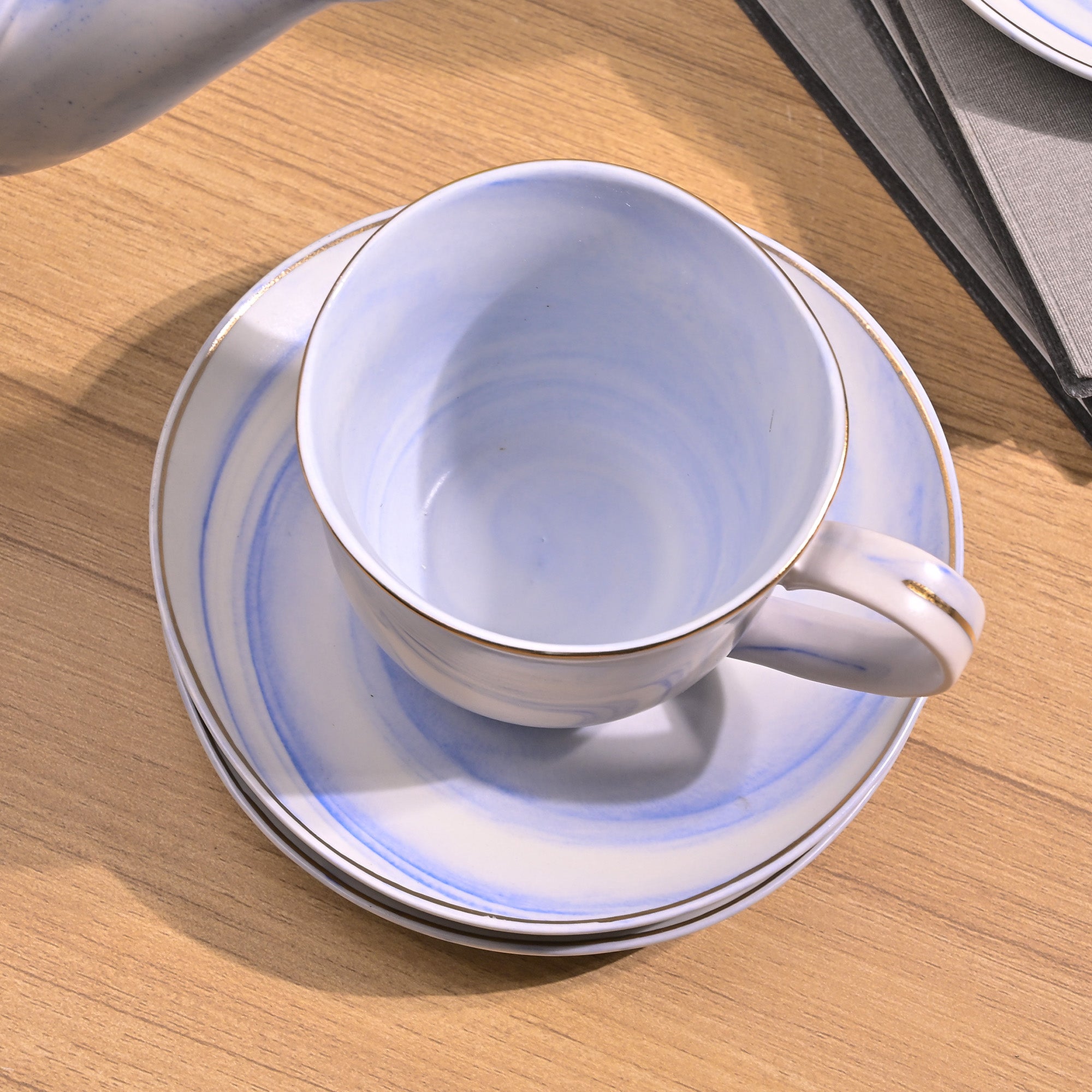 Sky blue tea kettle set on table

