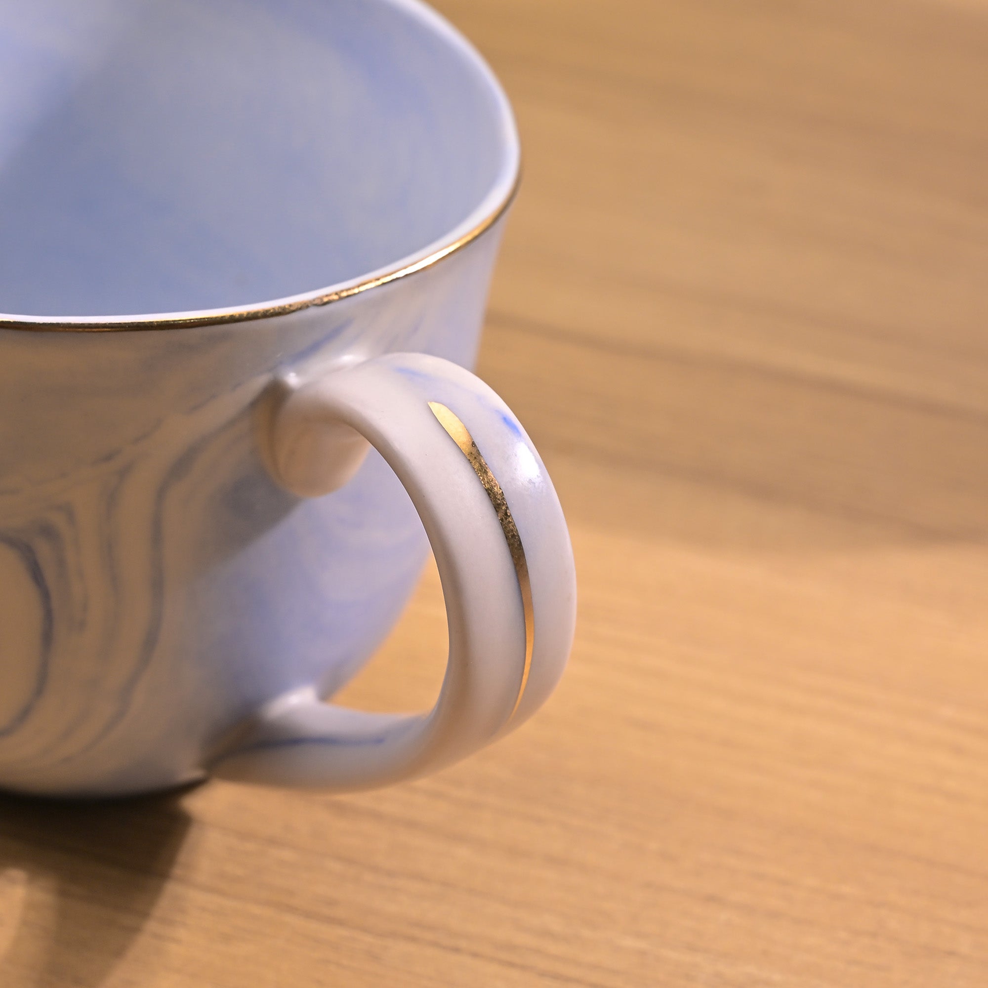 Faded blue tea kettle with cups

