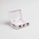 Handcrafted white marble jewelry box with delicate floral patterns

