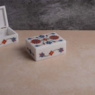 Decorative white marble keepsake box with floral artwork

