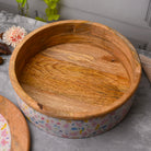 Decorative wooden casserole with intricate floral patterns

