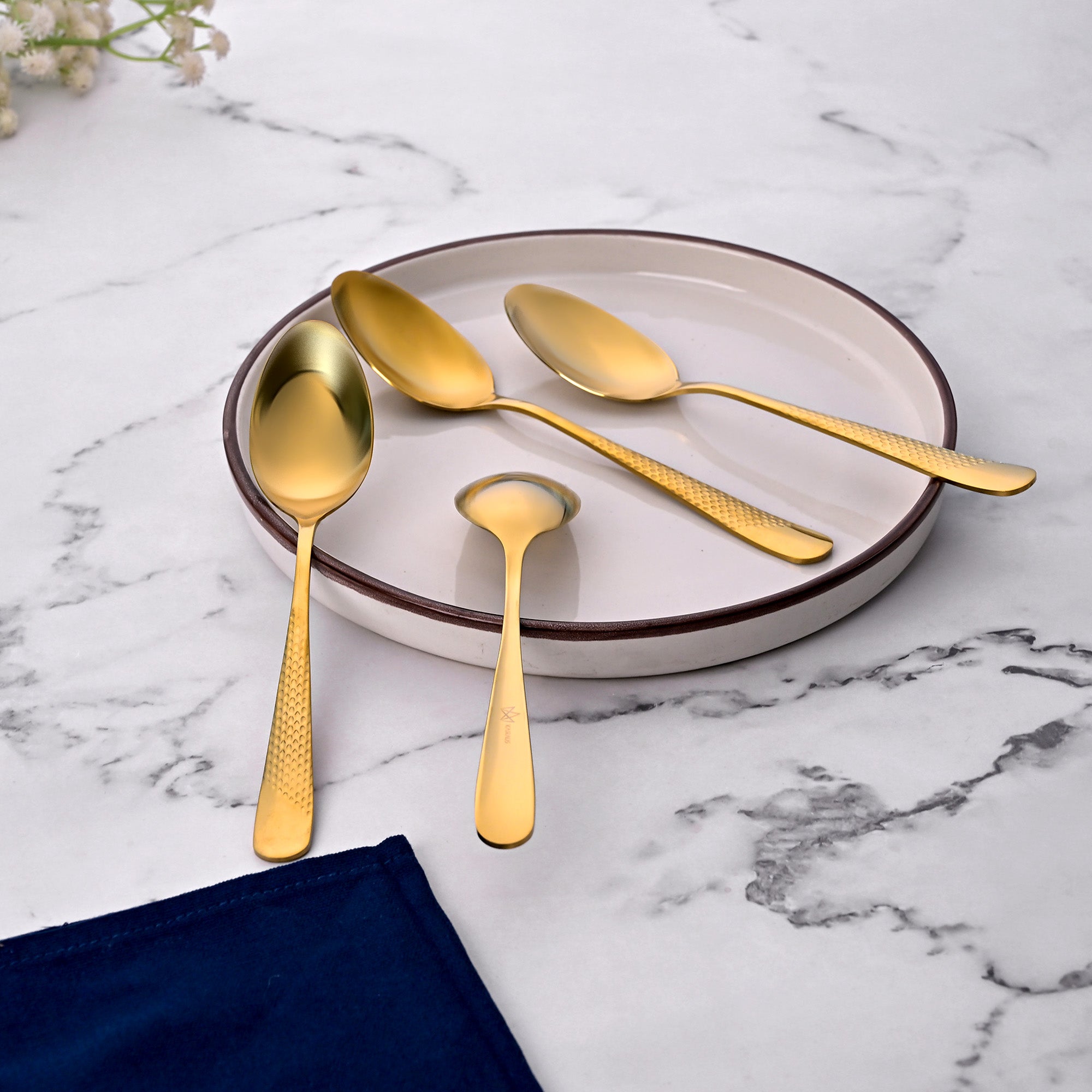 Close-Up of Golden Steel Spoons with Hammered Texture

