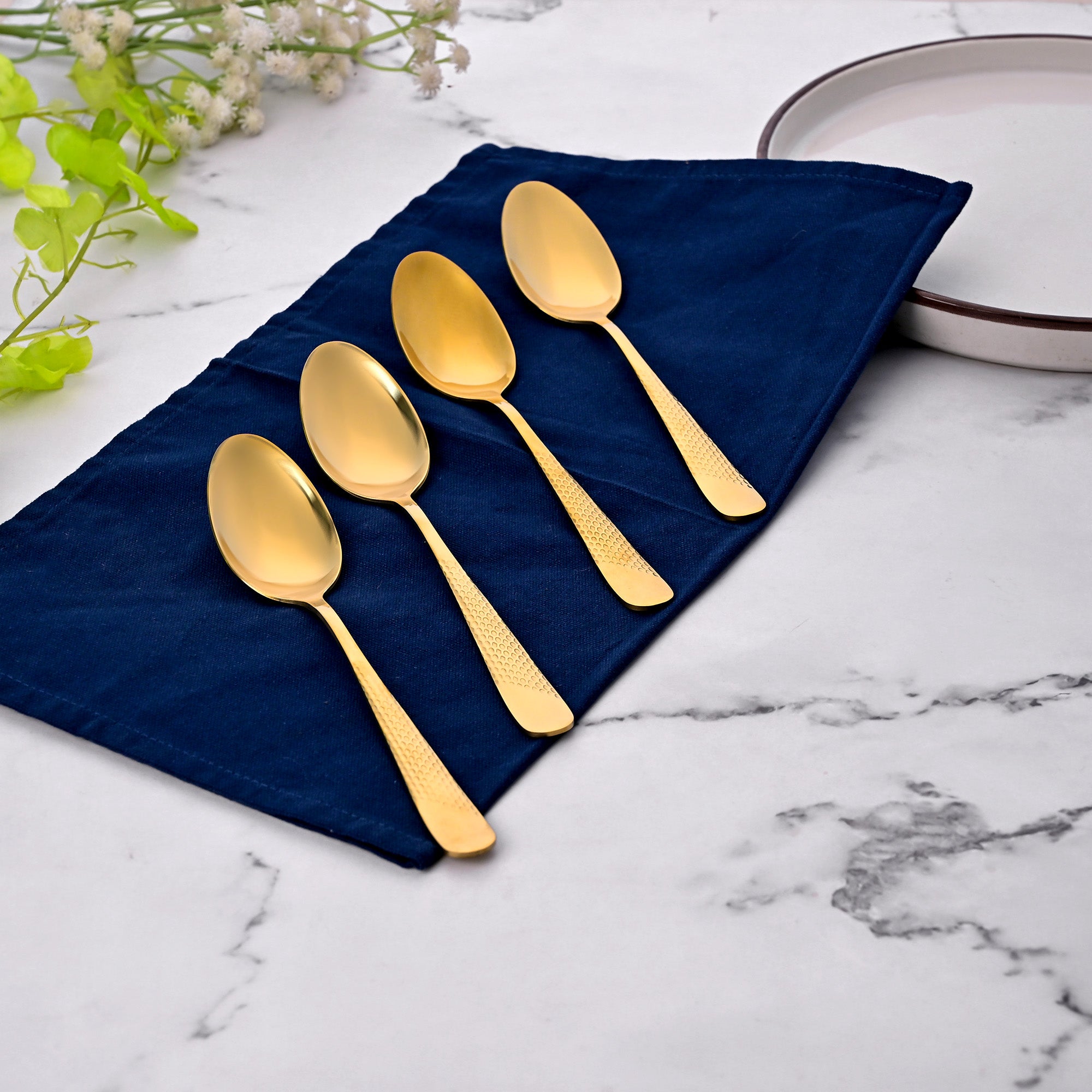 Golden Hammered Steel Spoons Set of 4 Displayed Elegantly

