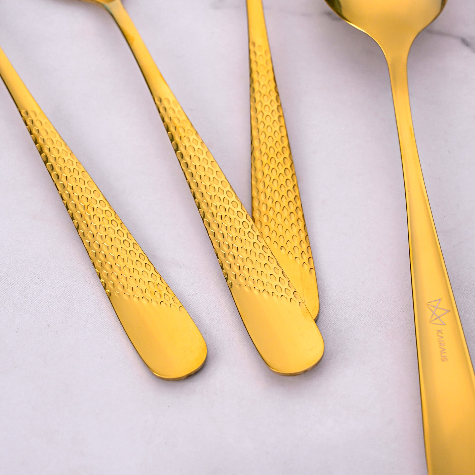 Elegant Gold Steel Spoons Featuring a Unique Hammered Design

