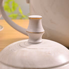 Side View of Greige Tea Kettle Showing Handle and Spout