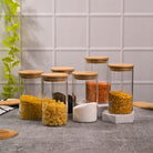 Clear glass food storage jars with wooden lids for pantry

