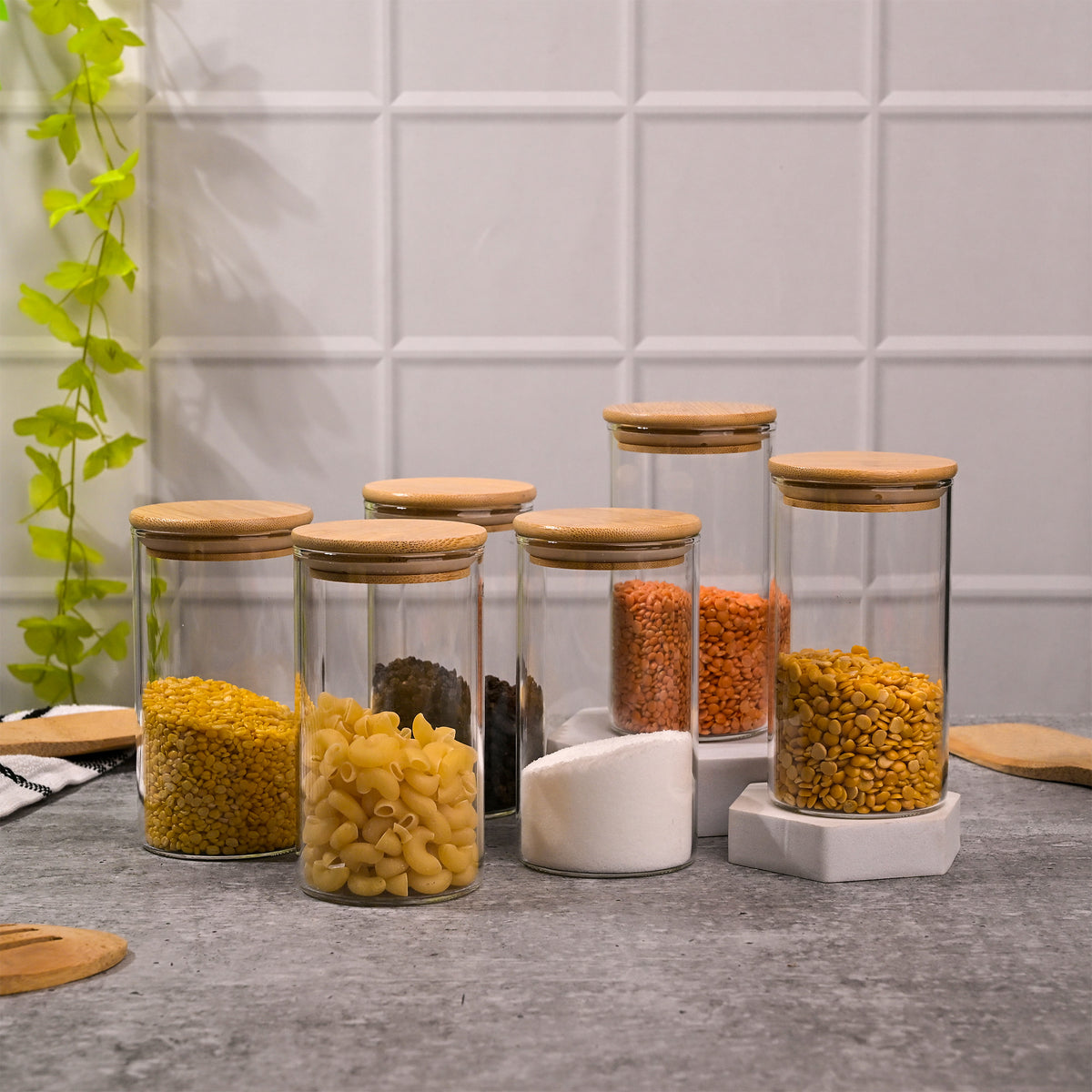 Clear glass food storage jars with wooden lids for pantry
