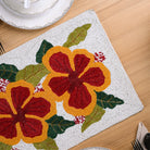Handmade beaded table mat with hibiscus design
