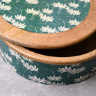 Handcrafted wooden casserole with intricate lotus detailing

