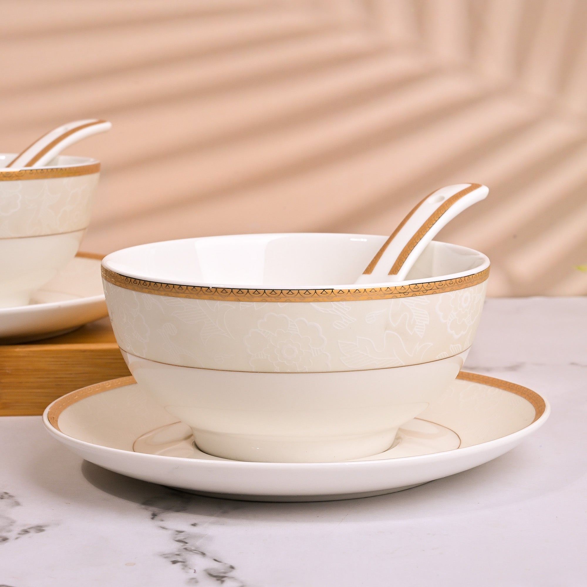 Opulent gold-rimmed soup bowls for elegant dining

