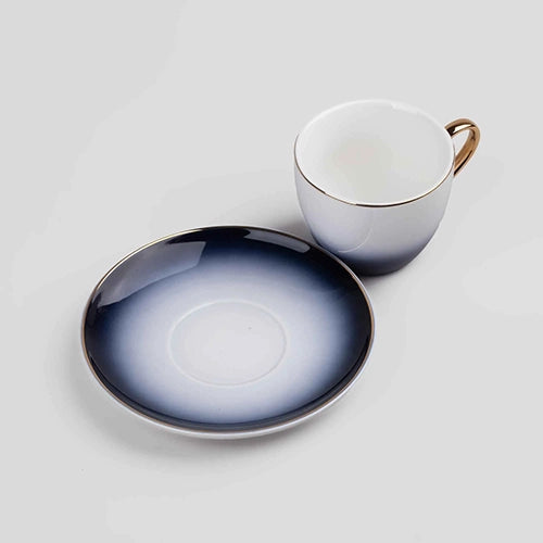 Four Blue Porcelain Tea Cups Displayed on Open Kitchen Shelves