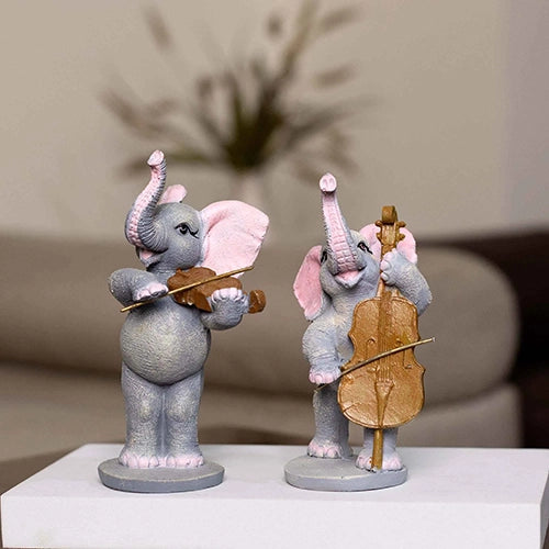 Decorative elephant statues playing music in a three-piece set

