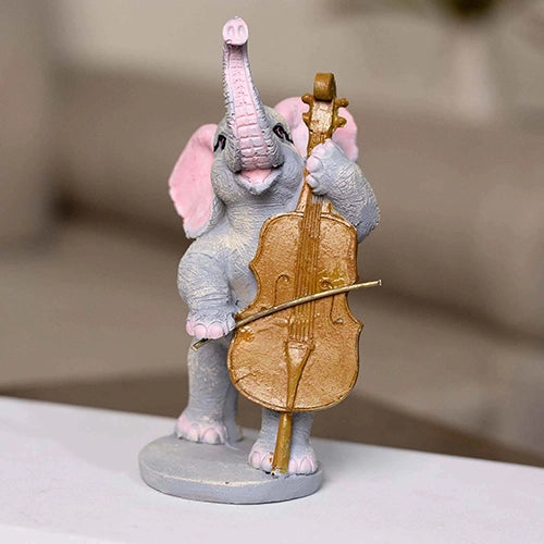 Three elephants playing instruments in a decorative statue set

