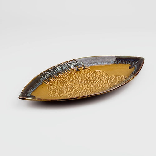Mustard yellow ceramic platter with leaf lace design


