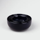 Set of four black serving bowls


