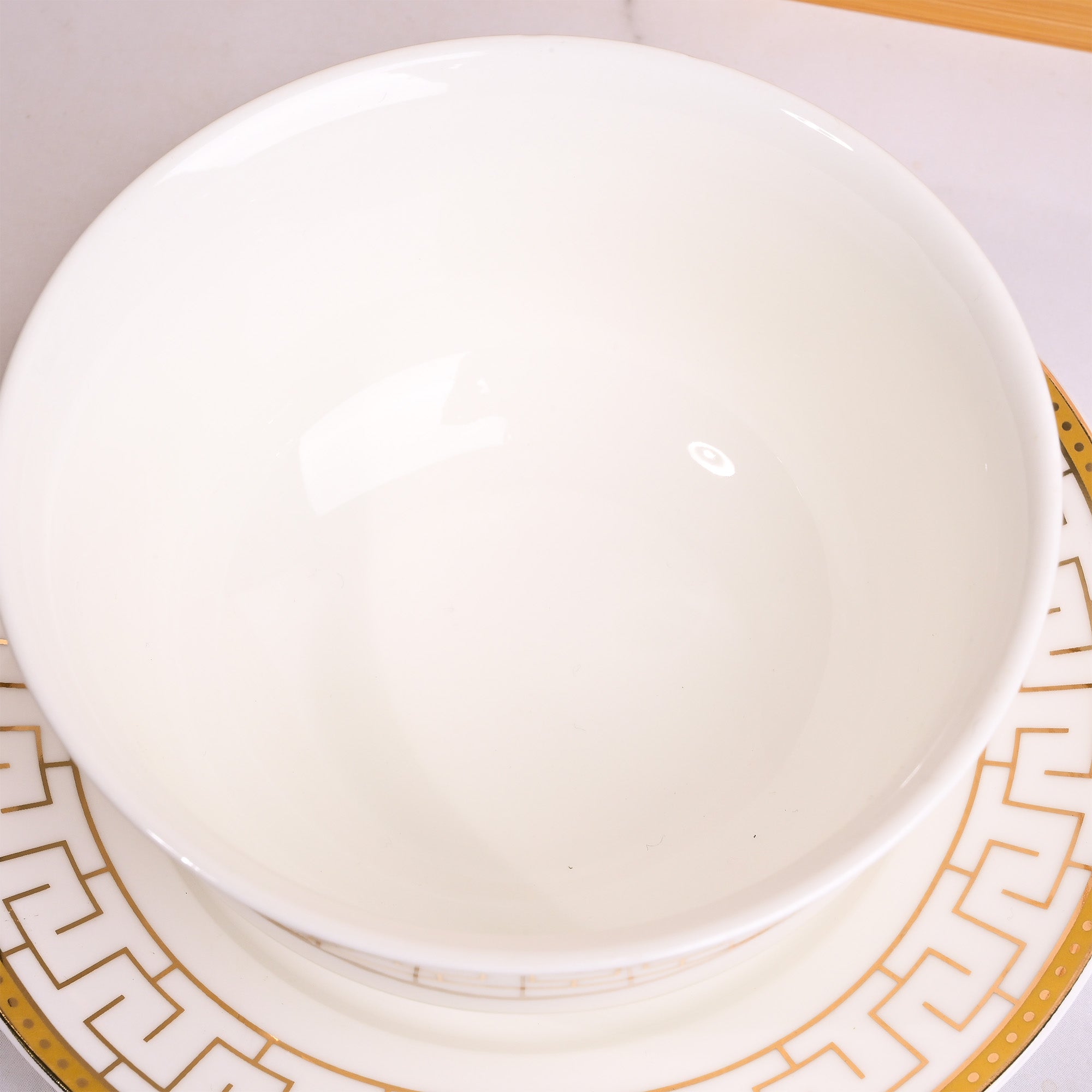 Set of two elegant white bowls with matching saucers

