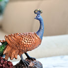 Decorative peacock statue carved on a tree trunk

