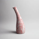 Decorative red and white vase featuring a textured finish

