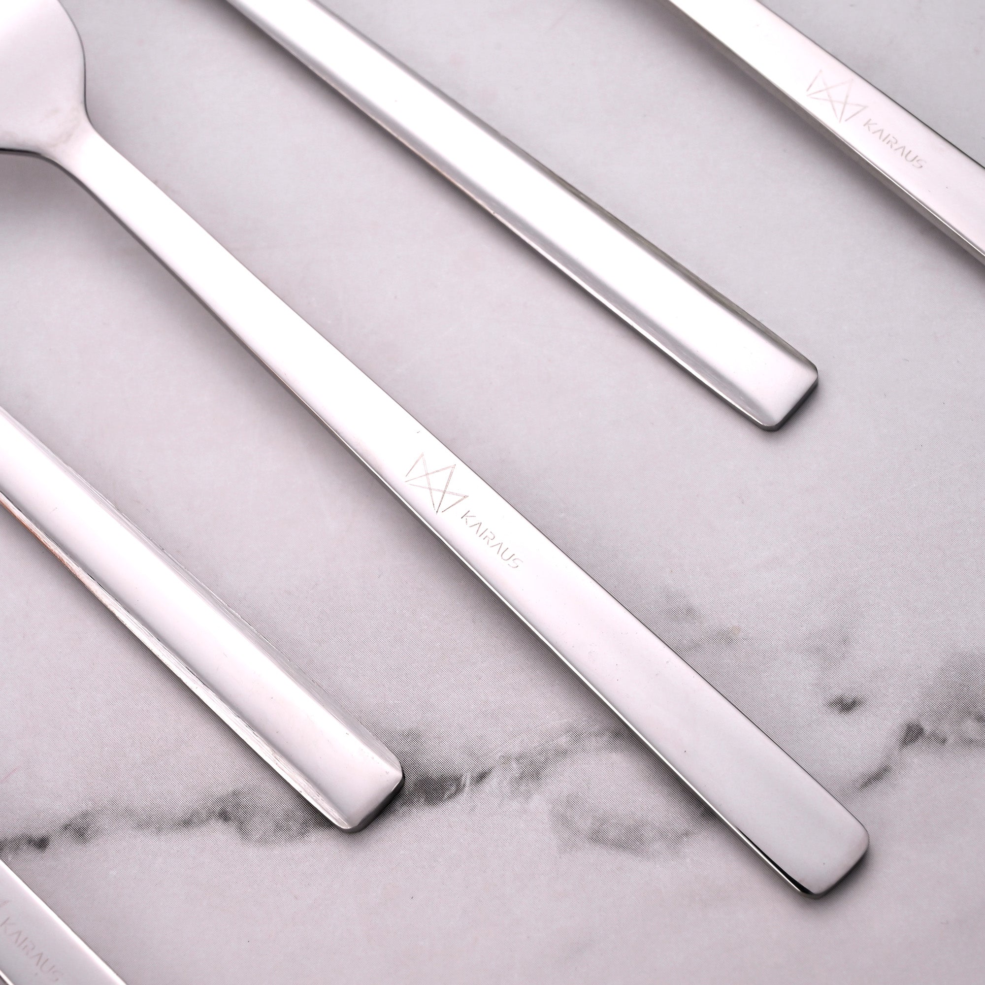 Close-Up View of Silver Charm Mini Forks with Shiny Details

