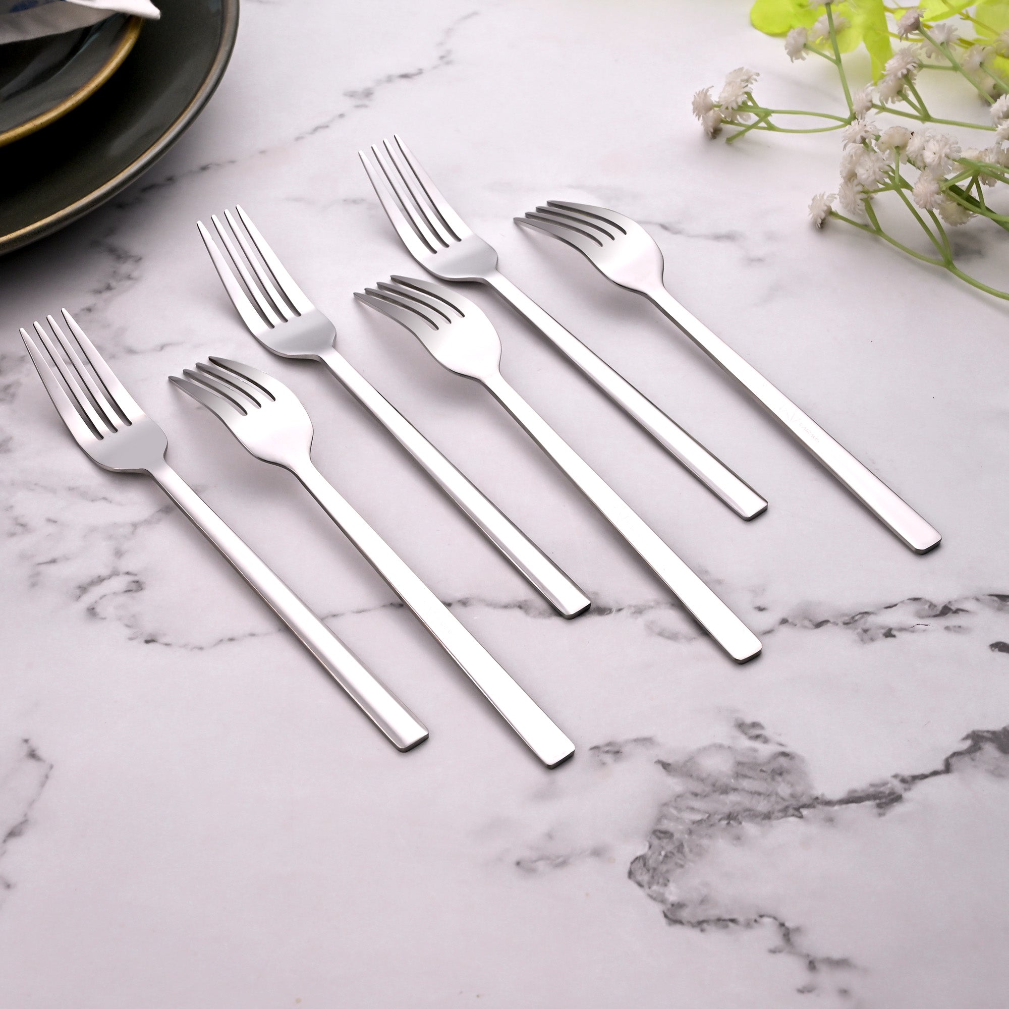 Close-Up View of Silver Charm Mini Forks with Shiny Details

