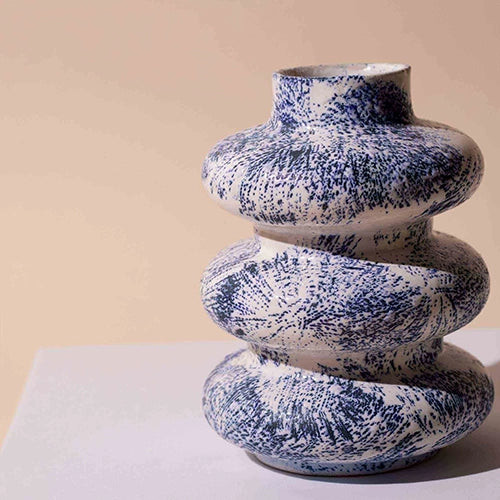 Sculptural ceramic vase with three interconnected rings

