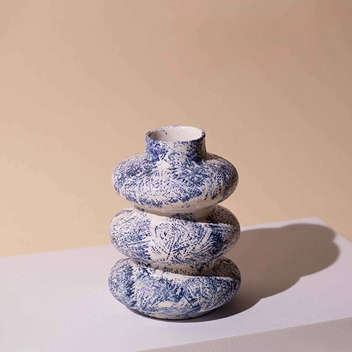 Artistic ceramic vase with a distinctive three-ring design

