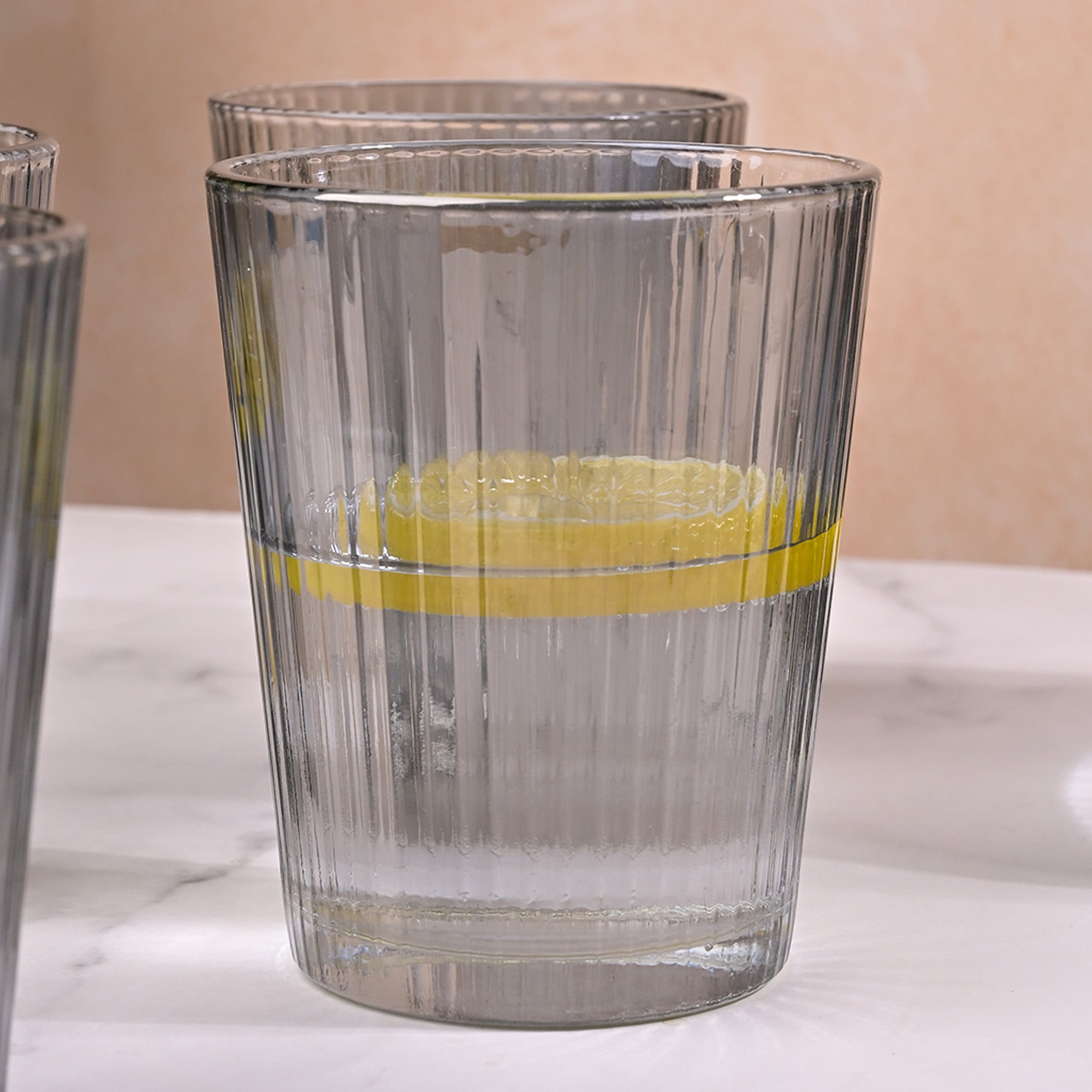 Minimalist grey-tinted glass jug and matching glasses for home use


