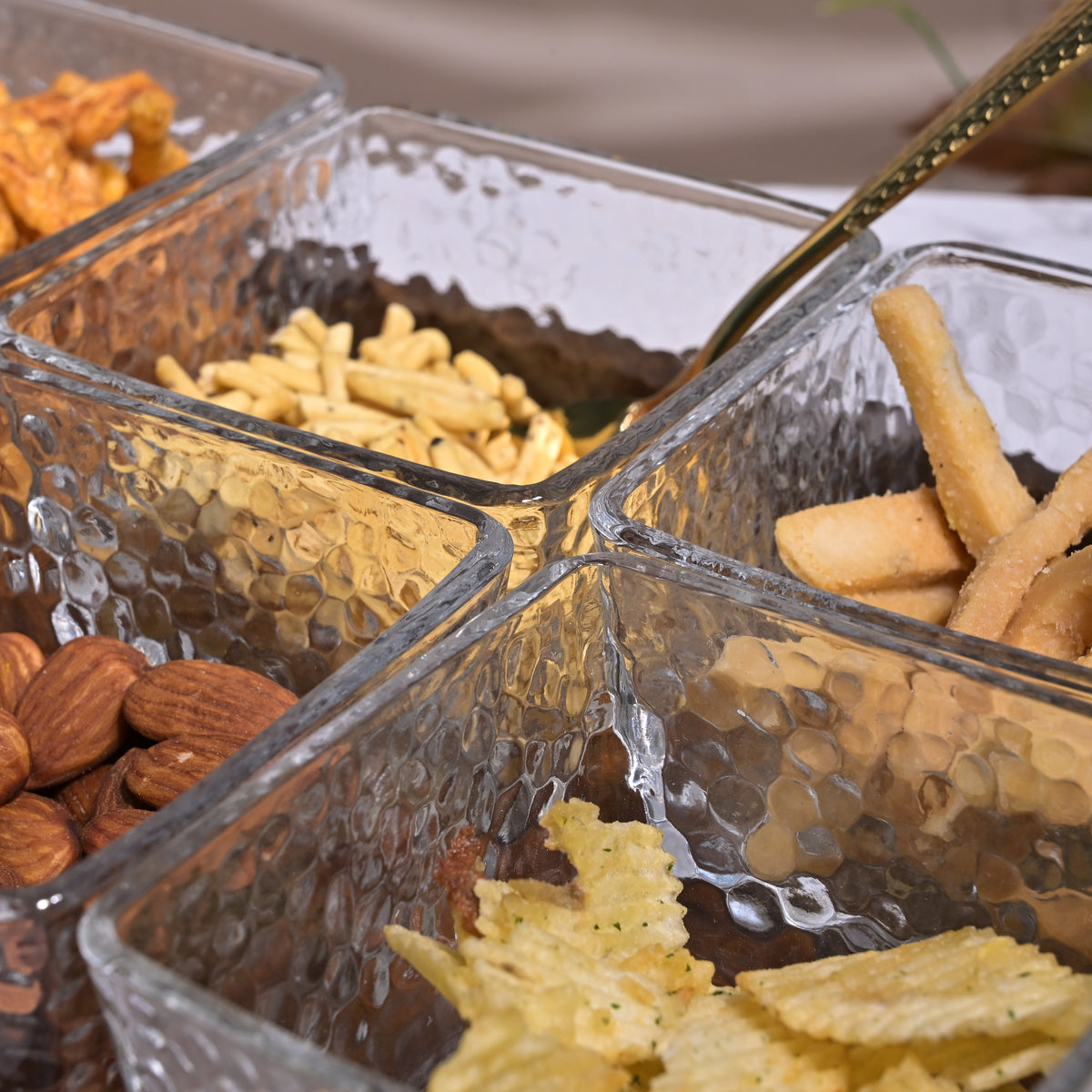 Glass bowl and tray arranged on dining table

