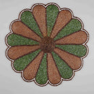 Green and white beaded table mat with starry design
