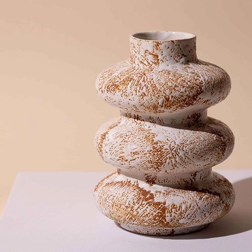 Sculptural ceramic vase with three interconnected rings

