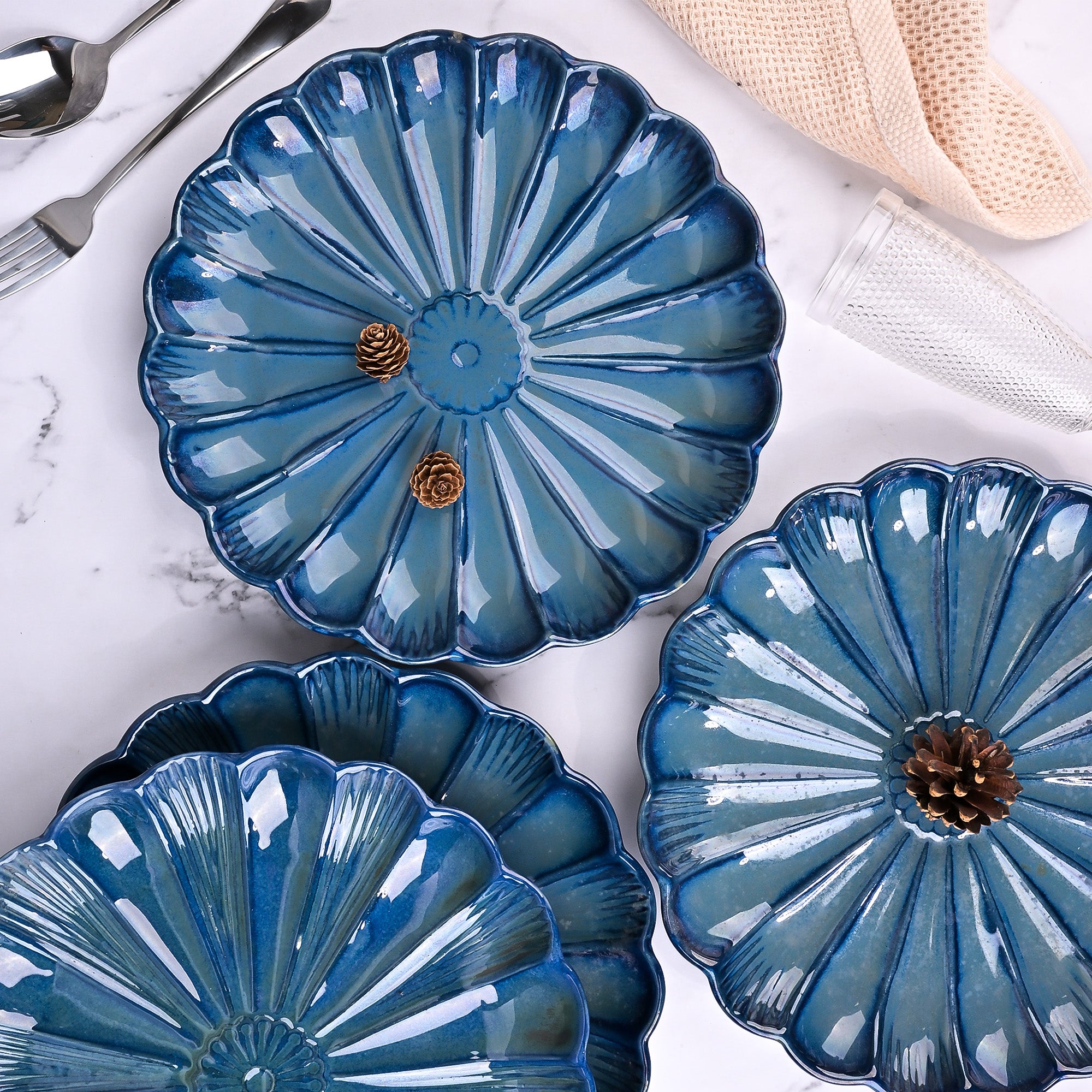 Set of four teal blue flower shaped plates


