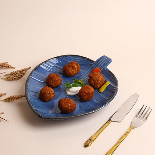 Decorative teal ceramic platter with leaf design

