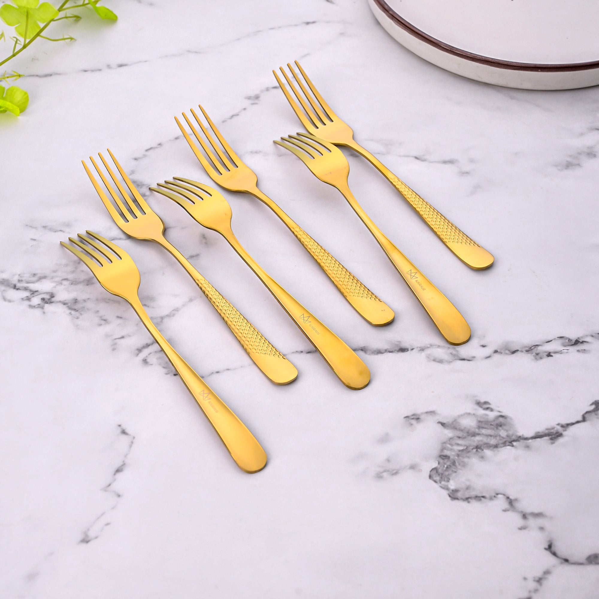 Close-Up View of Timeless Golden Forks with a Shiny Finish

