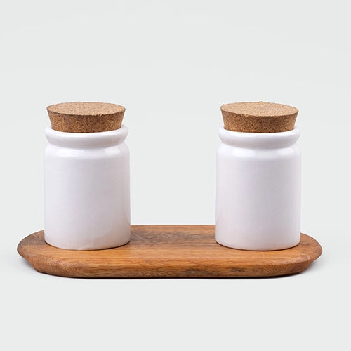 White ceramic condiment jars set with wooden lids
